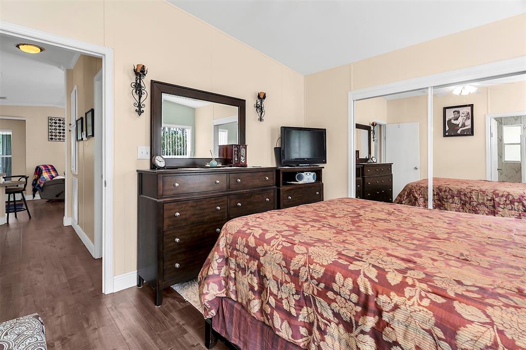 809 Putter Place Pompano Beach, FL 33069 - Photo 34 of 51 a bedroom with a bed and a flat screen tv