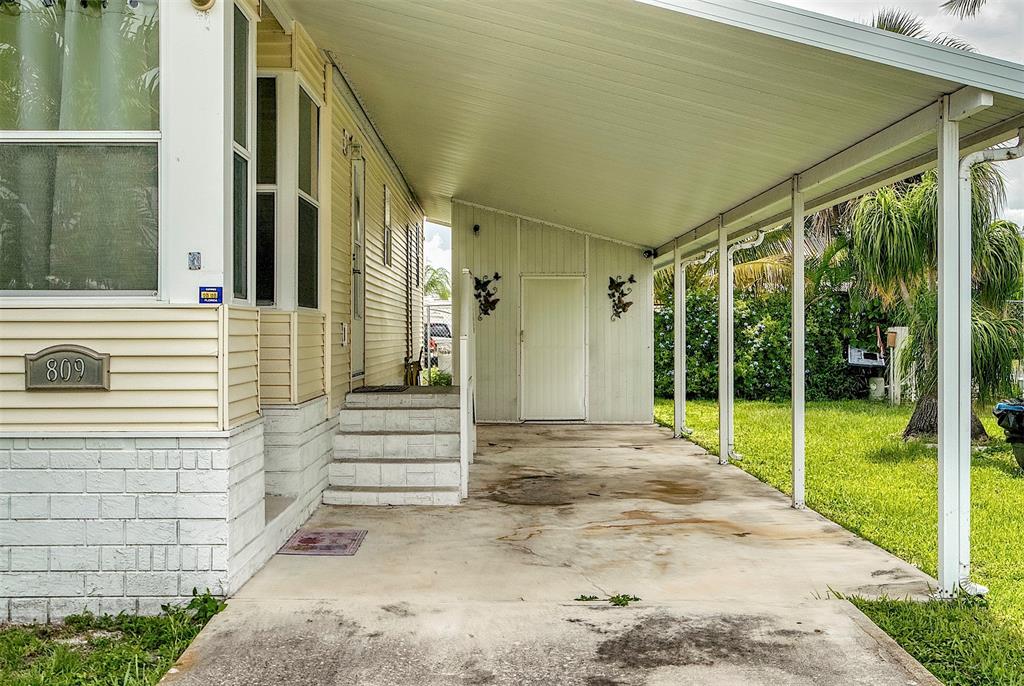 809 Putter Place Pompano Beach, FL 33069 - Photo 4 of 51 Entrance/Driveway/Covered Parking/Storage Shed