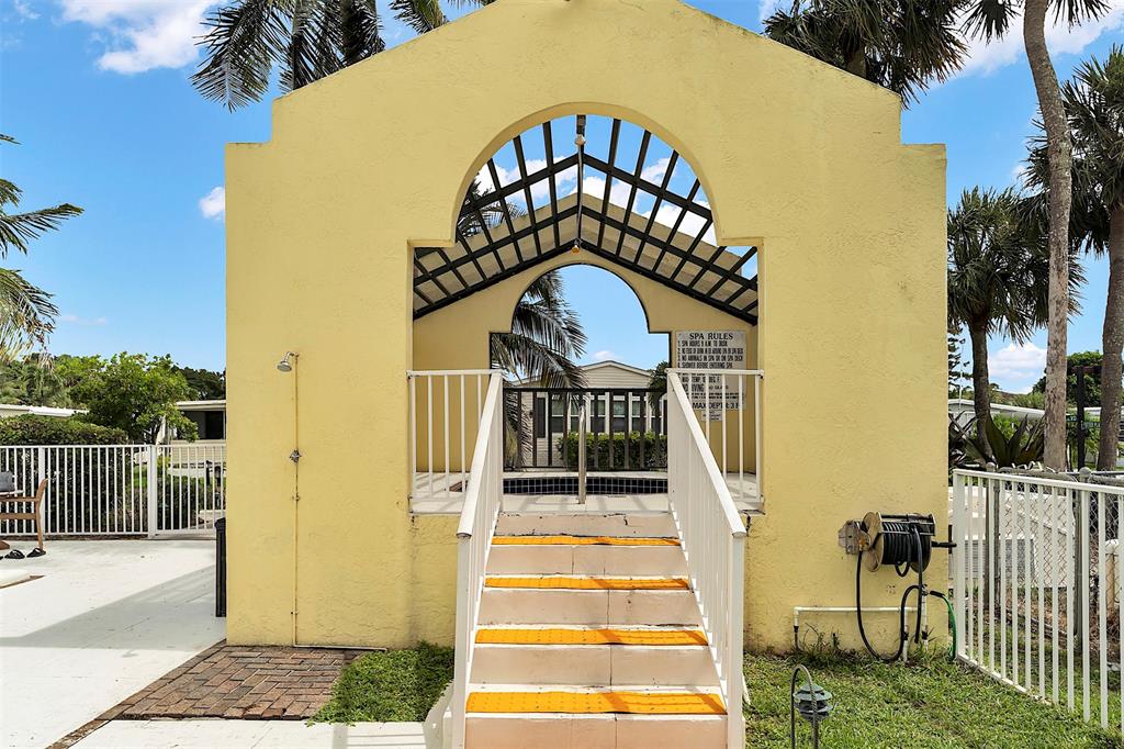809 Putter Place Pompano Beach, FL 33069 - Photo 48 of 51 a front view of a house with a yard