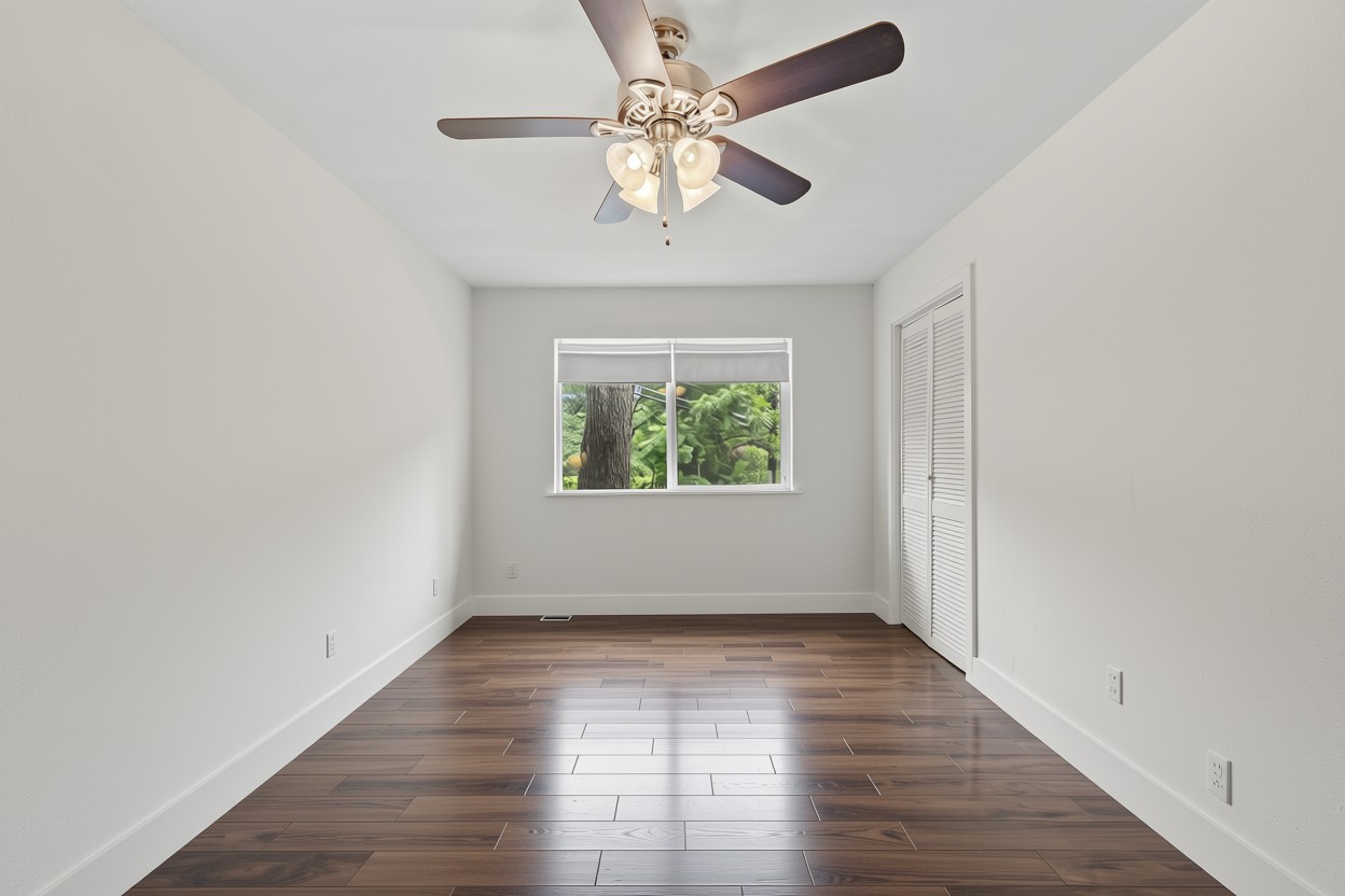 3302 Cherrywood Road Austin, TX 78722 - Photo 16 of 34 wooden floor in an empty room with a window