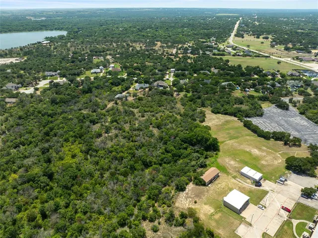 an aerial view of residential house with outdoor space and trees