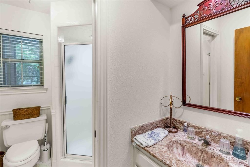 216 McMillen Road Lucas, TX 75002 - Photo 21 of 36 a bathroom with a granite countertop sink a toilet and a mirror