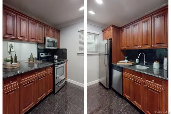 a kitchen with granite countertop wooden cabinets stainless steel appliances a sink and a window