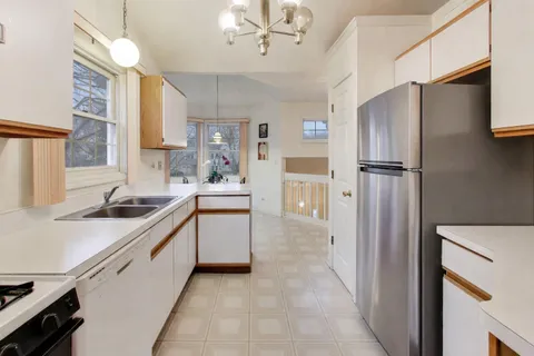 a kitchen with stainless steel appliances a sink stove and refrigerator