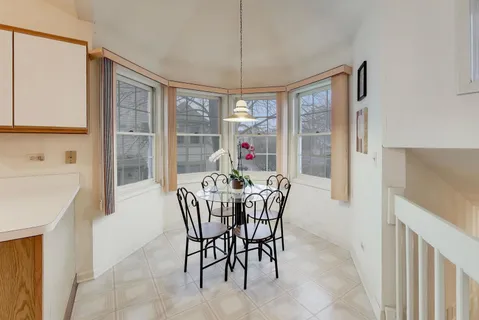 a dining room with furniture a chandelier and wooden floor