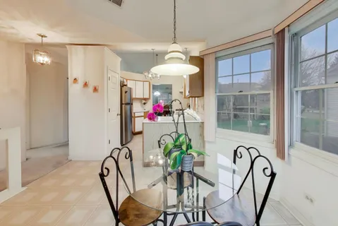 a view of a dining room with furniture front door and wooden floor
