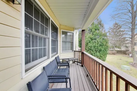 a view of balcony with wooden floor and fence
