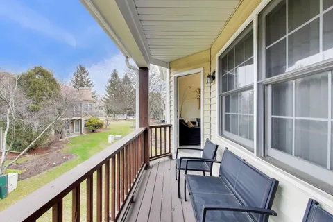 a view of balcony with furniture