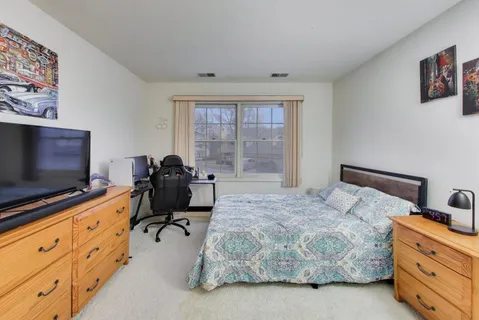 a bedroom with a bed and flat screen tv