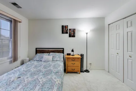 a bedroom with a bed and a night stand