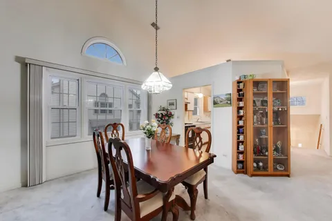 a view of a dining room with furniture and chandelier