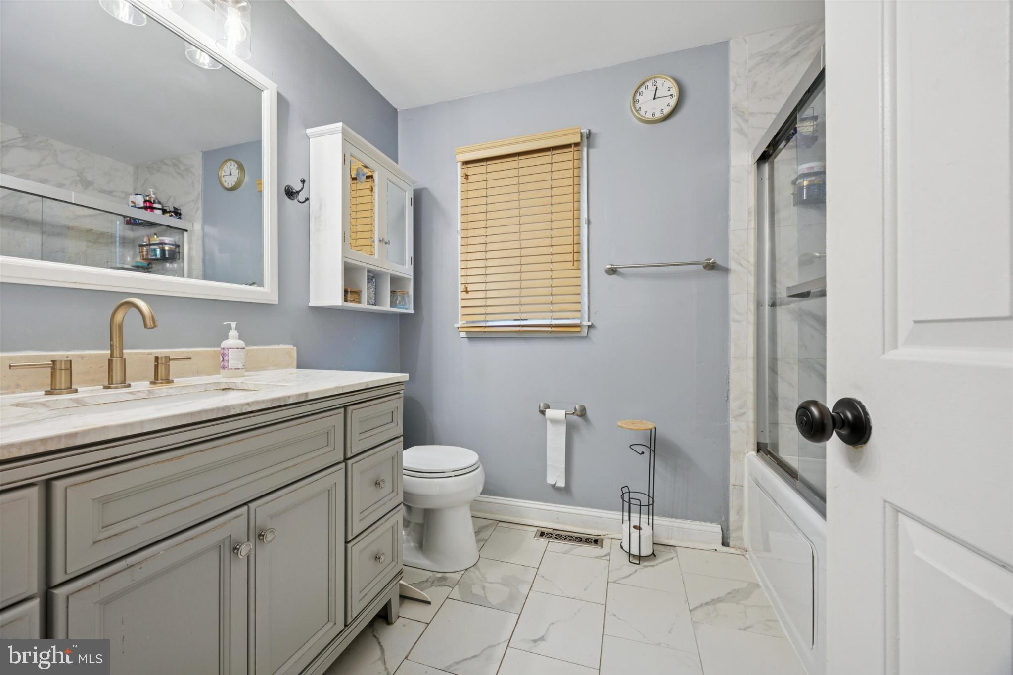 506 Flora Circle Springfield, PA 19064 - Photo 21 of 35 a bathroom with a sink toilet a mirror and shower