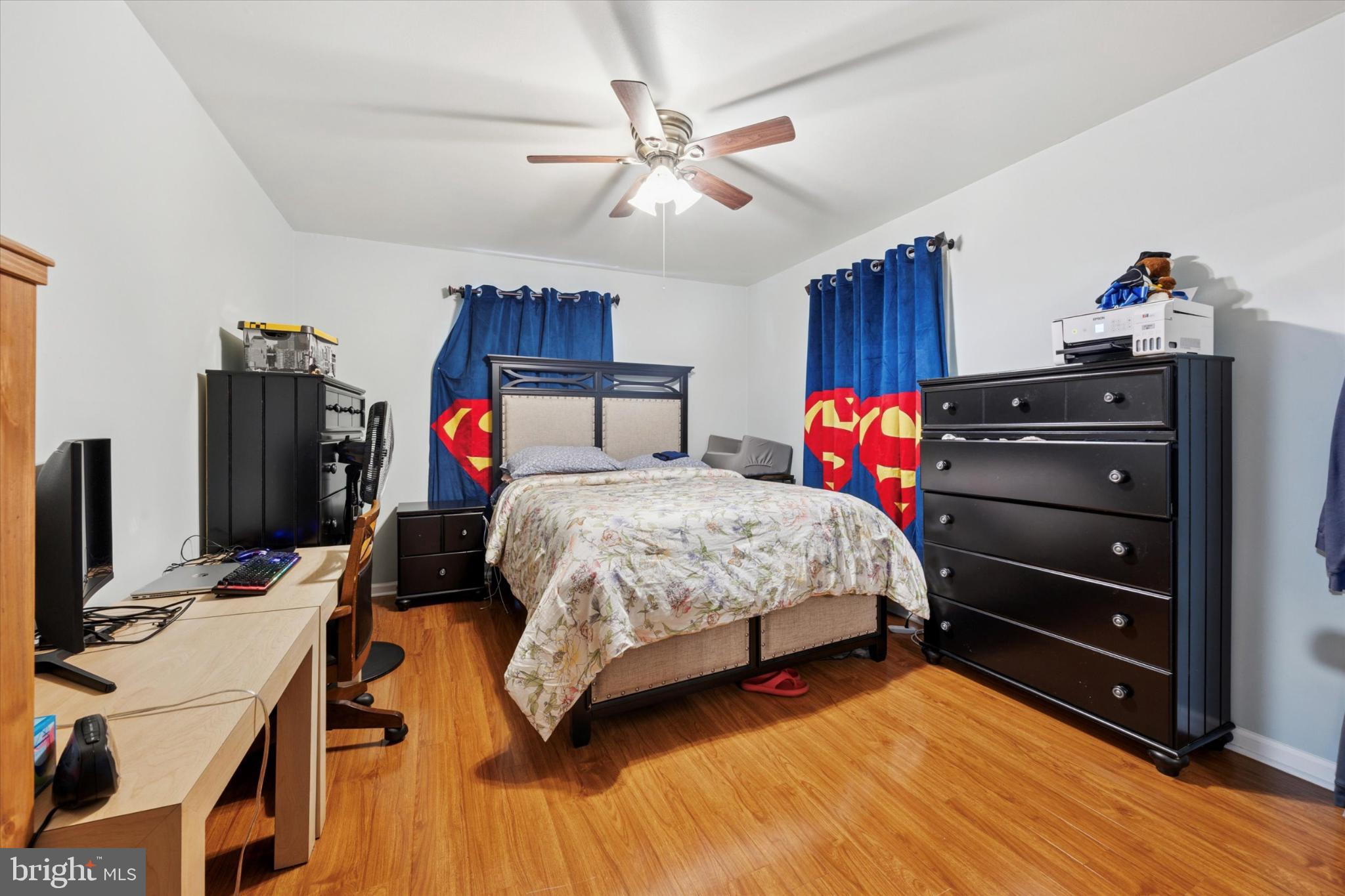 506 Flora Circle Springfield, PA 19064 - Photo 26 of 35 a bedroom with a bed and a chandelier