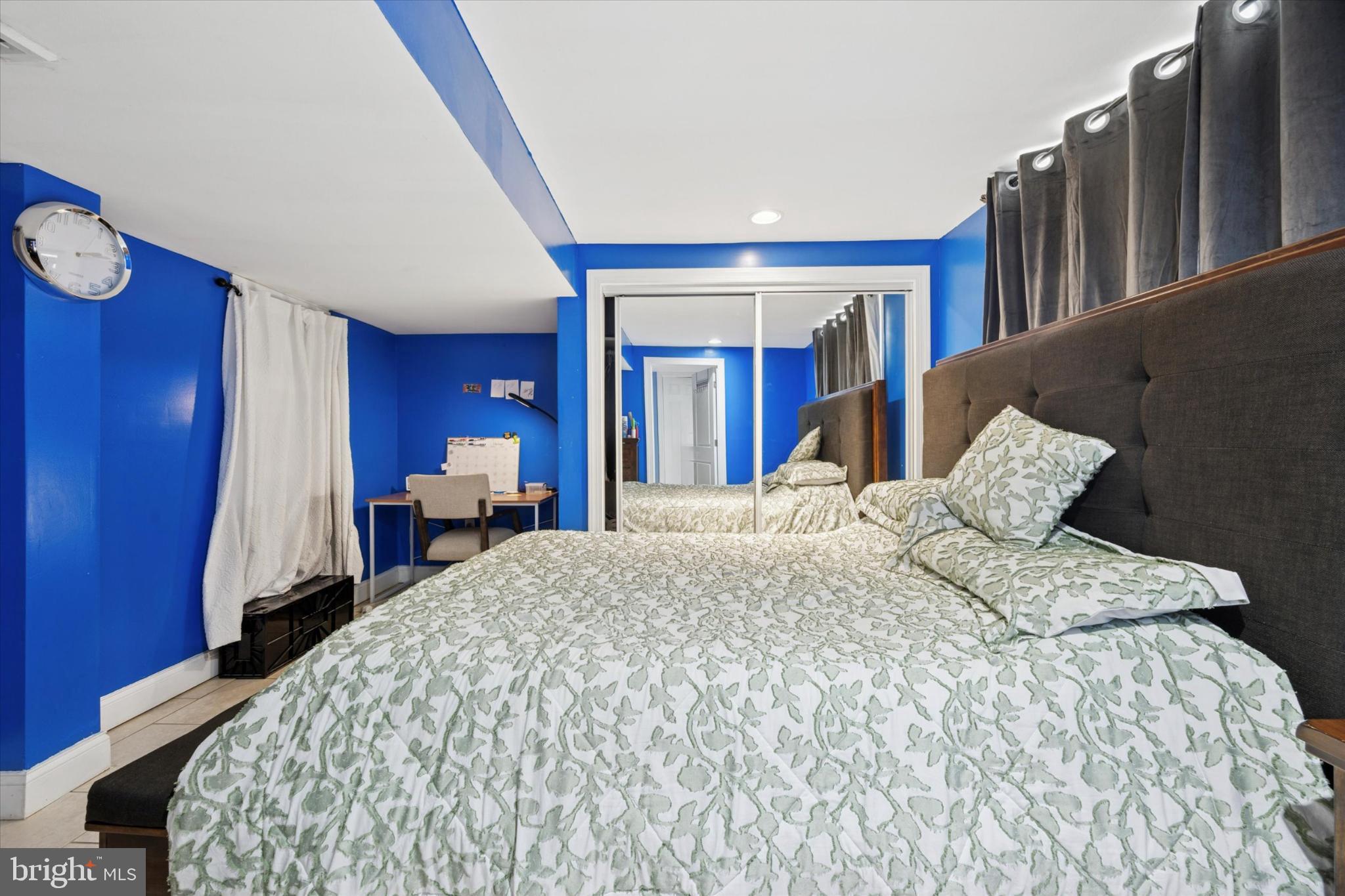 506 Flora Circle Springfield, PA 19064 - Photo 31 of 35 a large bedroom with wooden floor and chair