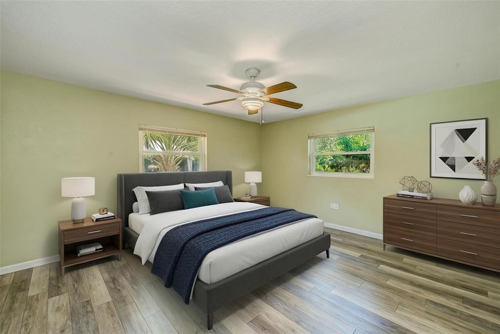 14079 Victoria Road Largo, FL 33774 - Photo 21 of 46 a bedroom with a bed and a chandelier