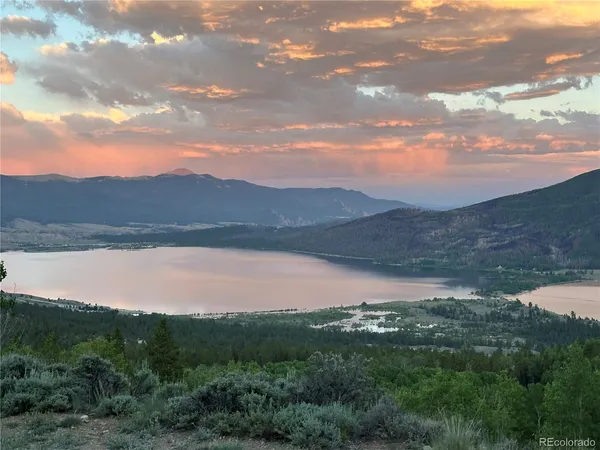 a view of a lake in middle of a forest