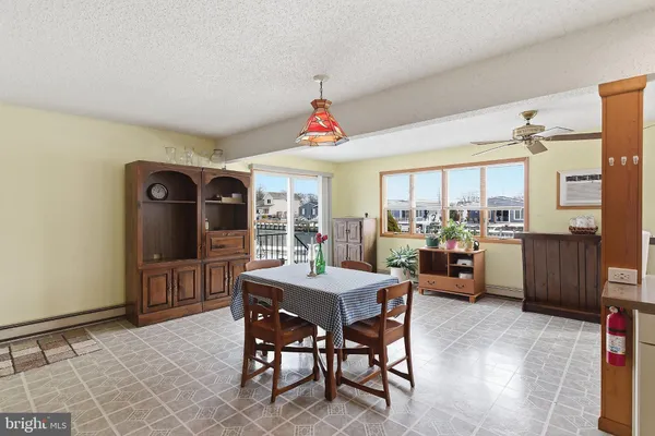a dining room with furniture and window