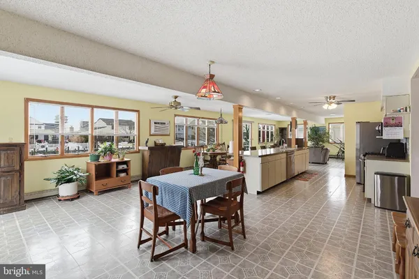 a large kitchen with a table and chairs
