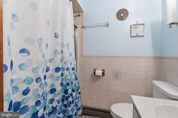 a white toilet sitting next to a bathroom sink