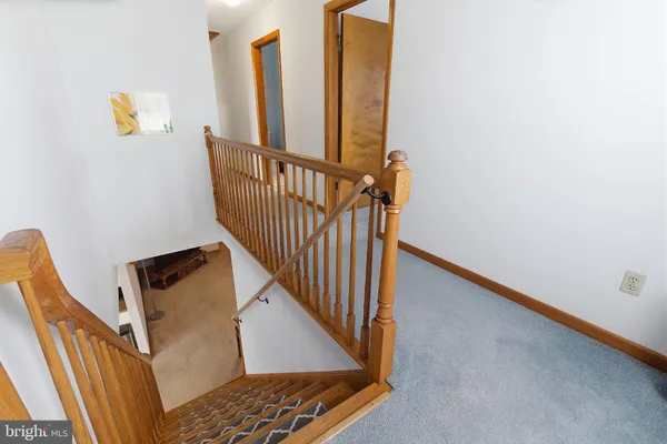 a view of staircase with railing and black white door