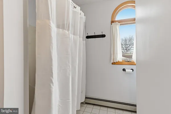 a bathroom with a painting on the wall