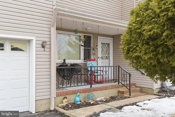 a view of a patio with a table and chairs and wooden fence