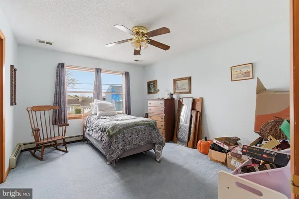 a living room with furniture a flat screen tv and a large window
