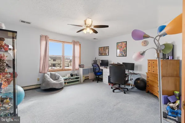 a view of a livingroom with workspace and a window