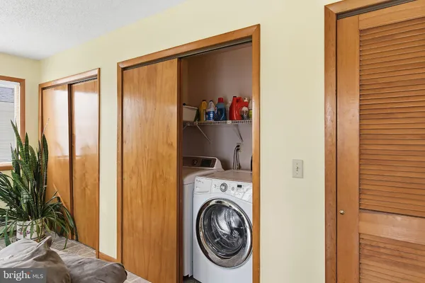 a view of a bedroom with washer and dryer