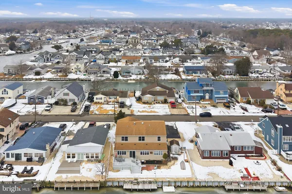 an aerial view of residential houses with city view