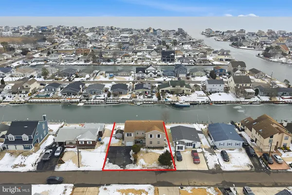 an aerial view of a house with a ocean view