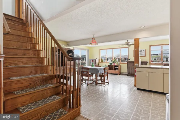 a livingroom with furniture kitchen view and windows