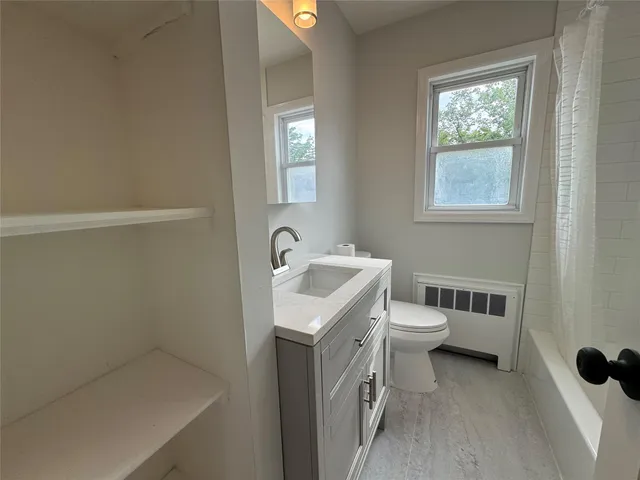 a bathroom with a toilet a sink and bathtub
