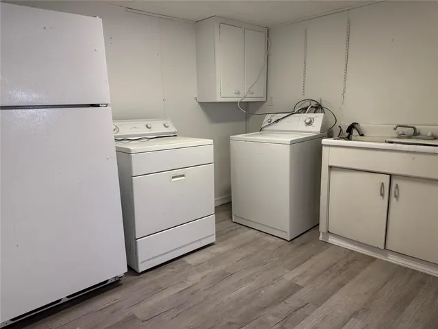 a bathroom with a sink toilet and a window