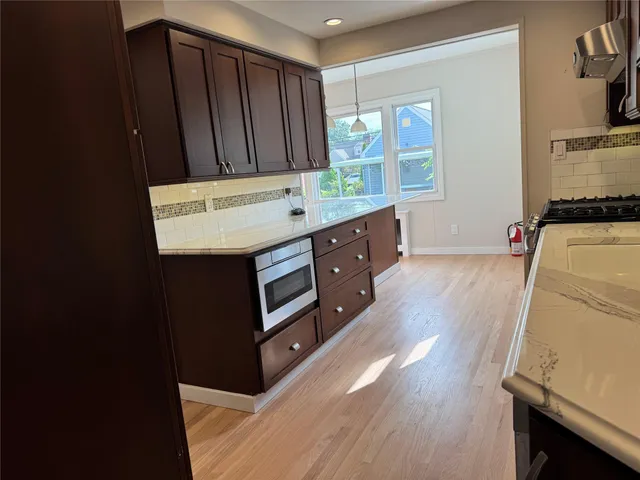 a kitchen with wooden cabinets and sink