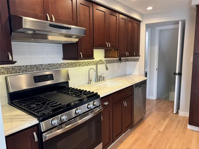 a kitchen with wooden cabinets and a stove top oven