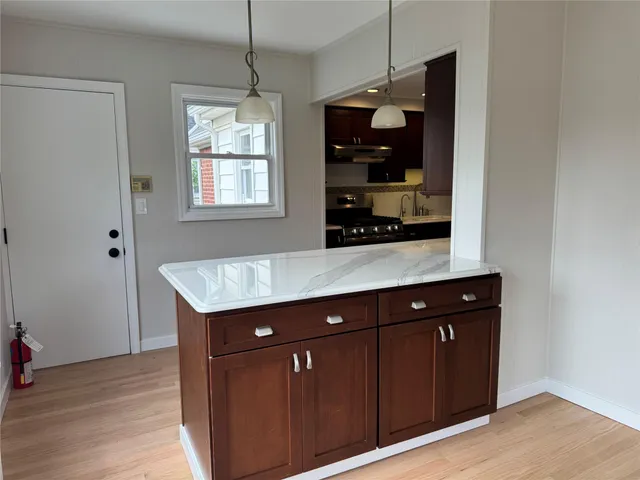 a room with granite countertop a sink and cabinets