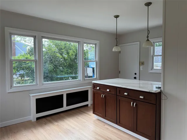 a kitchen with kitchen island a sink a stove and a wooden floor