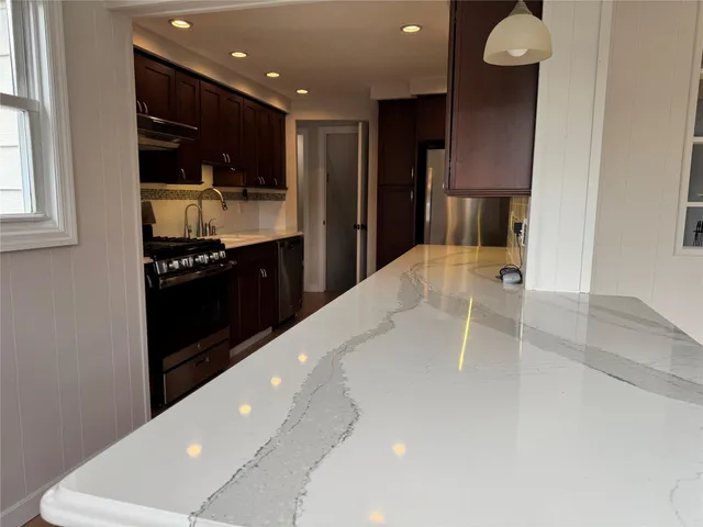 a kitchen with stainless steel appliances a refrigerator and a sink