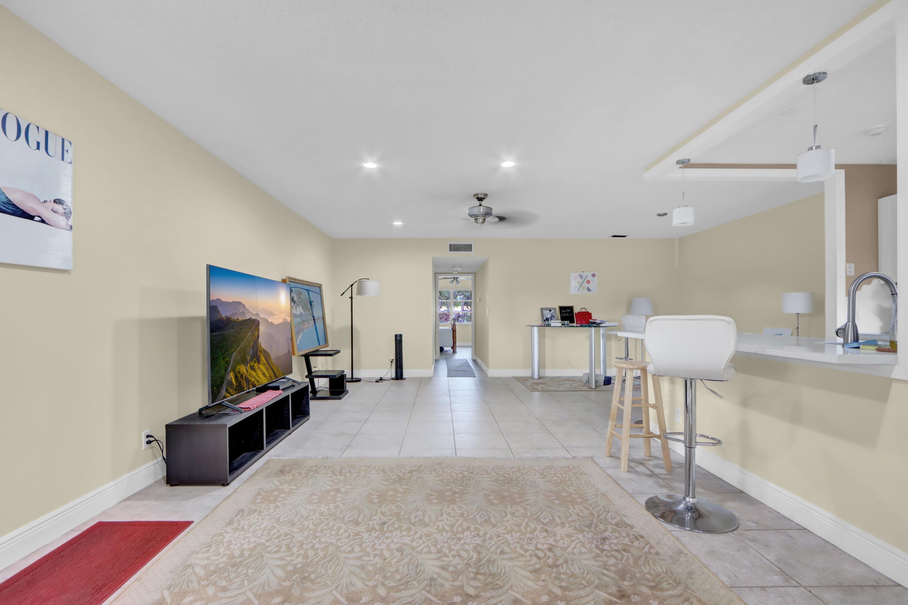 14050 Nesting Way, Unit B Delray Beach, FL 33484 - Photo 5 of 17 a living room with furniture and a flat screen tv