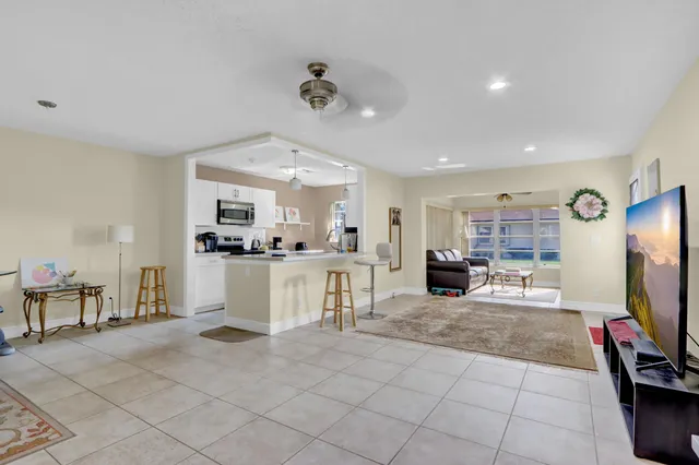 a view of living room kitchen and entryway