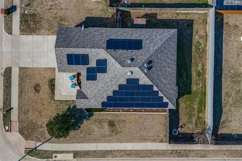 a aerial view of a house with a yard