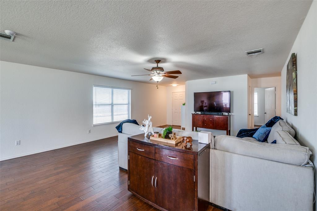728 Falcon Road Saginaw, TX 76131 - Photo 3 of 30 a living room with furniture and a flat screen tv