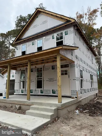 a view of a white house with large windows