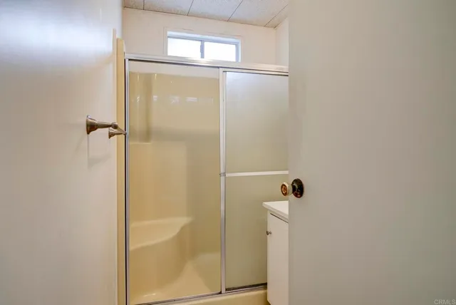 a bathroom with a glass shower door