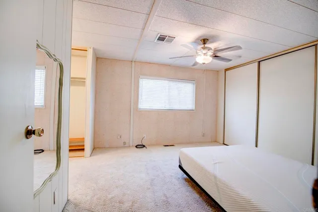 a bedroom with a bed dresser and a window