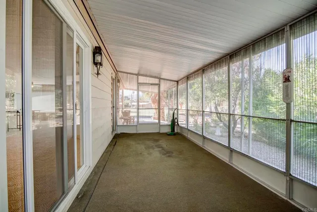 a view of an empty room with windows