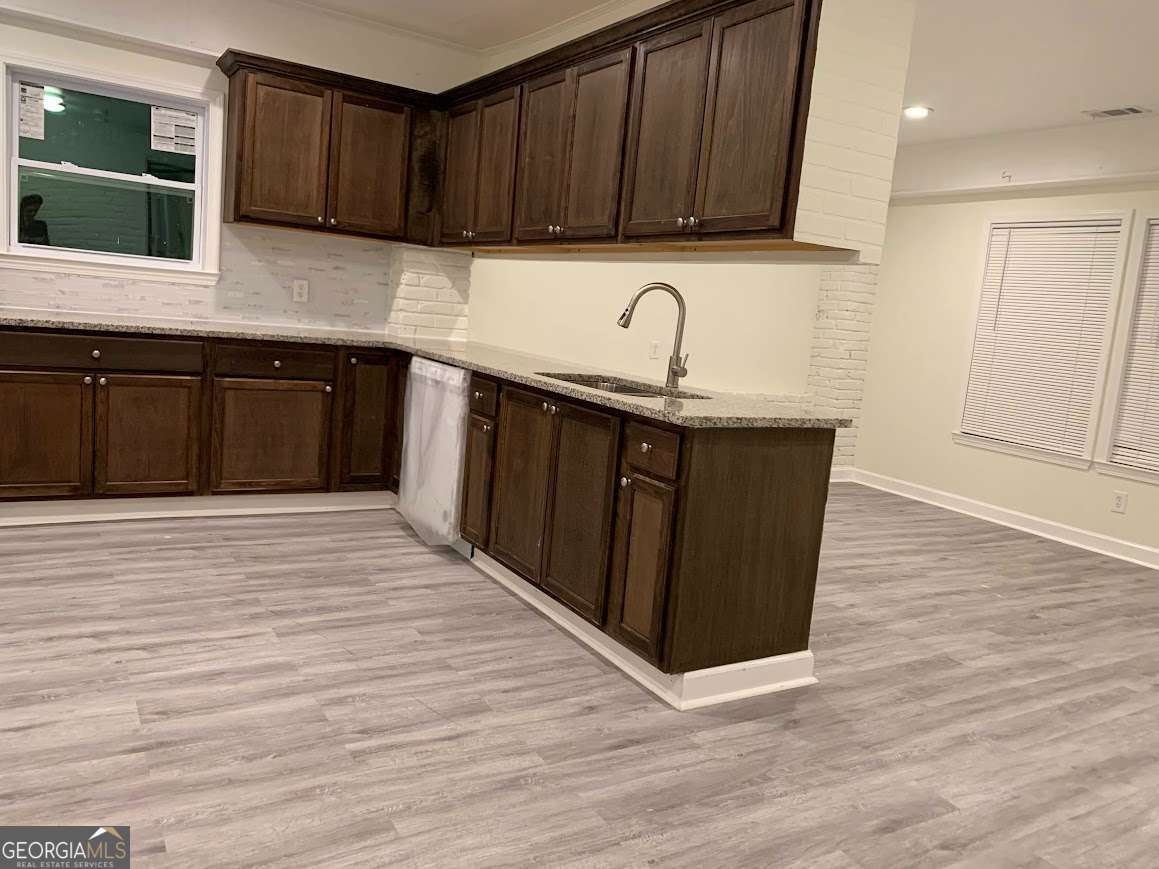 3019 Trafalgar Way Chamblee, GA 30341 - Photo 13 of 15 a kitchen with granite countertop wooden cabinets a sink and dishwasher