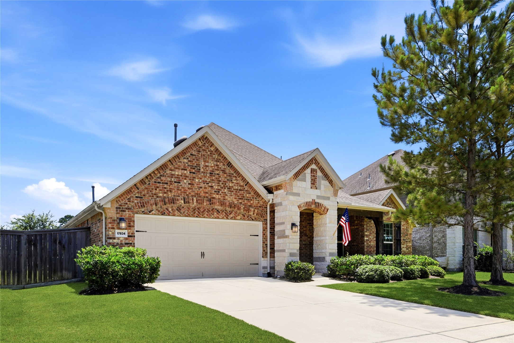 17834 Maple Ash Drive Spring, TX 77379 - Photo 3 of 50 Charming single-story brick home with a two-car garage and manicured front yard. Features a classic gable roof and a welcoming porch. Ideal for comfortable living in a friendly neighborhood.