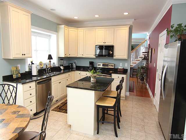 2500 Happy Lane Raleigh, NC 27614 - Photo 3 of 23 Kitchen has granite, smooth top range, convection oven,tile floor. Many cabinets have pull outs. Kitchen window is extended with nice wide granite window sill.